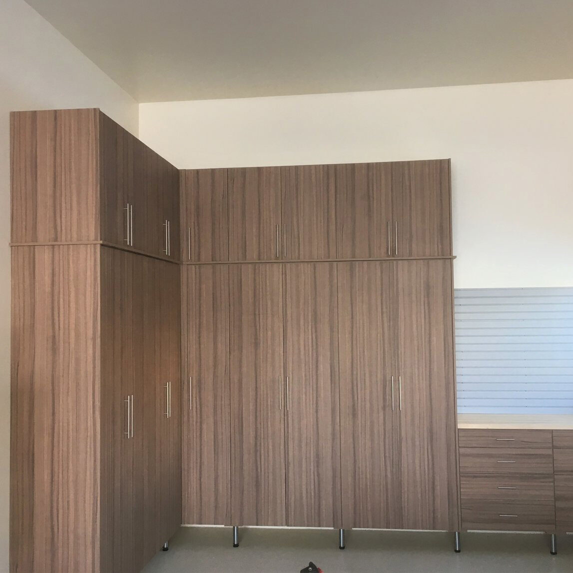 The closet butler custom garage with natural wood finish.