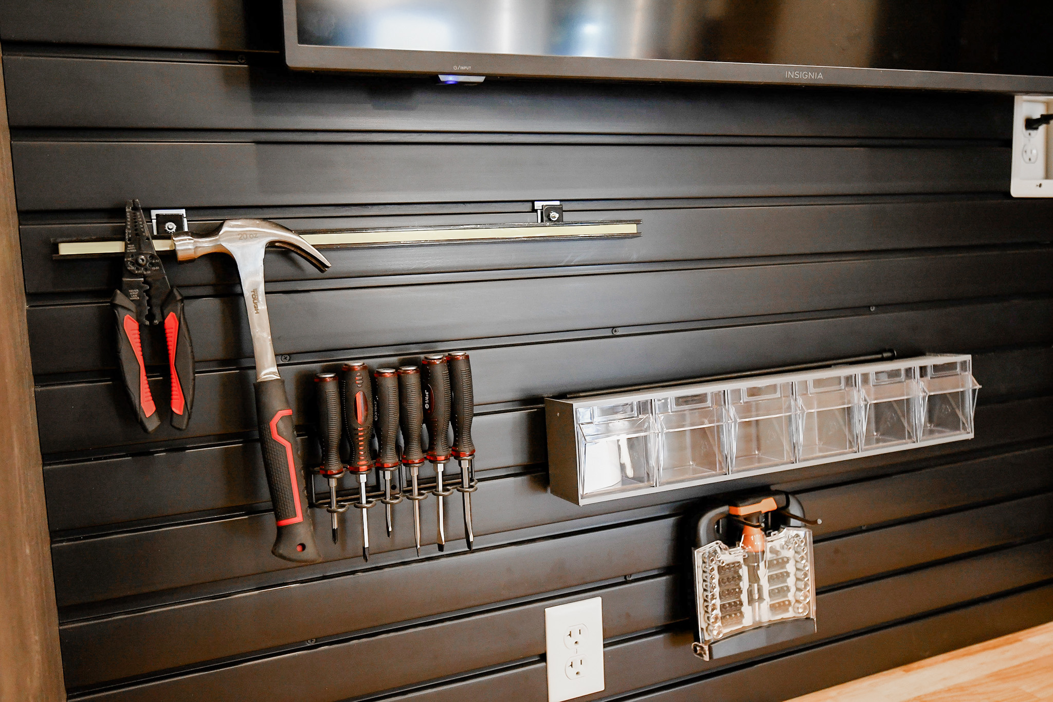 The Closet Butler’s Garage Tool Organization Custom designed slat wall system in a garage with house tools neatly organized on hooks.