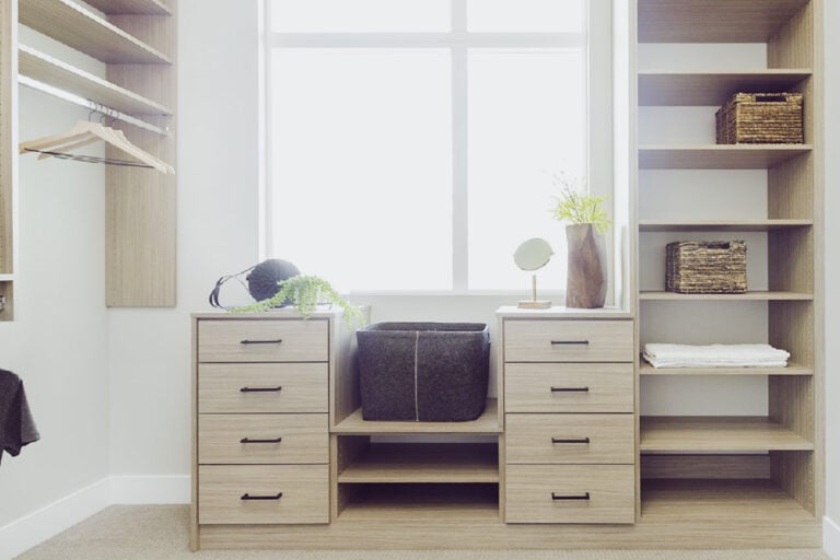 Custom closet featuring warm neutral wood finishes, organized shelves, and stylish hanging spaces for clothing and accessories.