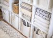A photo of a neatly organized linen closet, inspiring spring cleaning throughout your closets, with custom storage solutions from The Closet Butler