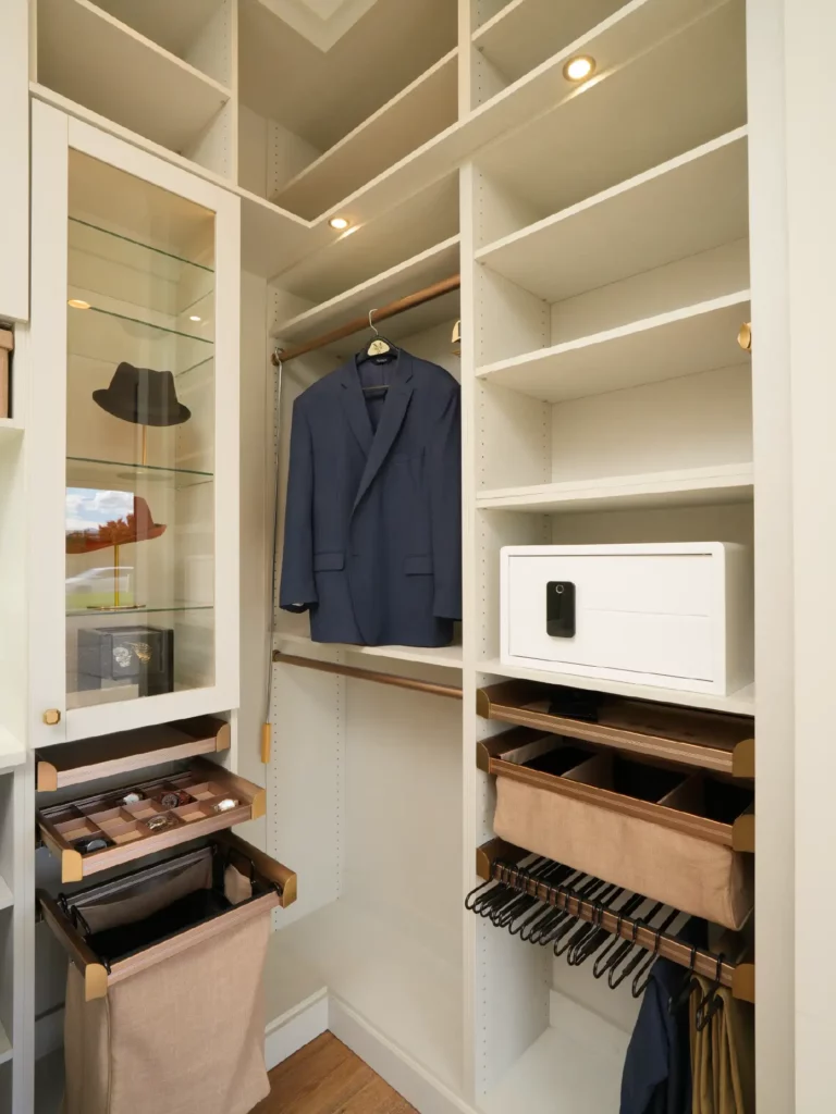 The closet butler trento showroom clothing showcase with accessory and safe.