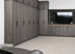 Modern garage with tall dark wood cabinets along the left wall and a silver sports car in the foreground.