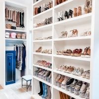 Custom white cabinet closet design showcasing a fully organized space with clothing, shoes, and accessories arranged neatly for optimal accessibility.