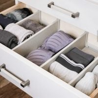 Contemporary closet design by The Closet Butler featuring specialized organization for bras and underwear, with compartments and dividers for easy access and neat presentation.